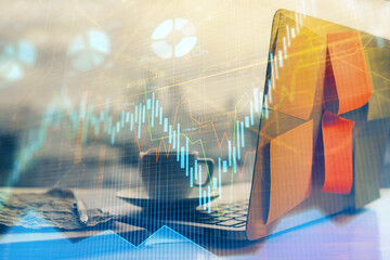 Financial chart drawing and table with computer on background. Multi exposure. Concept of...