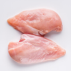 raw chicken fillet on a white acrylic background