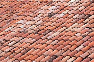 Vintage clay tiled roof. Multi colored old roof tiles background.