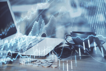 Financial chart drawing and table with computer on background. Double exposure. Concept of international markets.