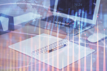 Financial graph colorful drawing and table with computer on background. Multi exposure. Concept of international markets.