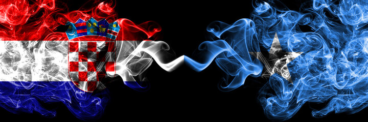 Croatia, Croatian vs Somalia, Somali smoky mystic flags placed side by side. Thick colored silky abstract smoke flags.