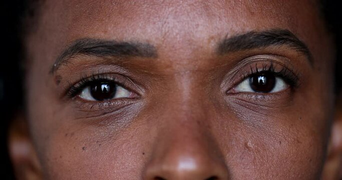 Black African woman opening eyes close-up face and eyes