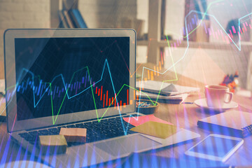 Financial graph colorful drawing and table with computer on background. Multi exposure. Concept of international markets.