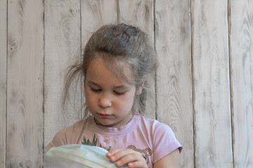 Fototapeta premium A small girl with a medical mask