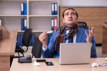 Young sick businessman employee suffering at workplace