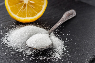 citric acid on a dark stone background