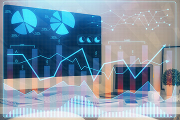 Financial chart drawing and table with computer on background. Multi exposure. Concept of international markets.