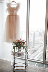 wedding bouquet and dress in the room