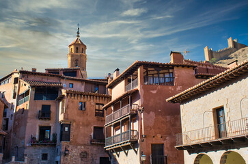 Traditional medieval architecture in the main square of Albarracin, Teruel. Bell tower of the parish of Santa Maria and Santiago, Spain