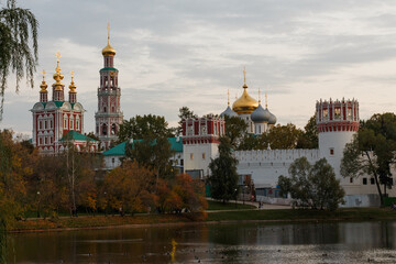 Fototapeta na wymiar Novodevichy Monastery in Moscow, Russia. Wall. Pond. Towers. Churches