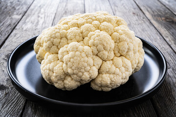 Fresh raw cauliflower on wooden table