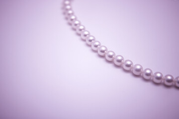 pearl necklace with copy space, the object is on purple background

