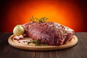 Fresh raw pork on cutting board on gradient color background