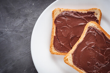 toasts with chocolate butter on a dark stone background