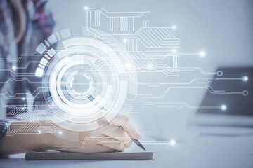 Double exposure of woman's writing hand on background with data technology hud. Big data concept.