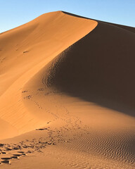 Fototapeta na wymiar Huge desert dune at Erg Chigaga, at the gates of the Sahara. Morocco. Concept of travel and adventure.