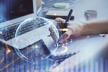 Double exposure of hands making notes with world map hologram and data theme icons. Concept of global computer data.