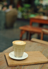 Cup of coffee on table in cafe - vintage style effect picture