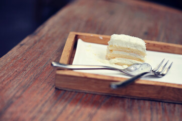 Cake Vanilla buttercream on a wood plate in cafe