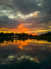 Cloudy sunset reflecting in Odra river