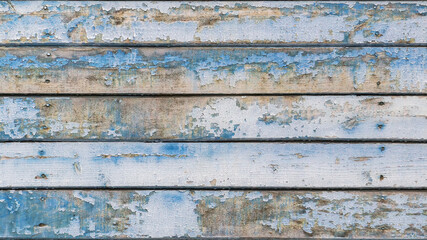Full frame image of the old wooden wall with exfoliated light blue paint. Horizontal texture of colorful painted wood for wallpaper or background. Empty template for design, copy space
