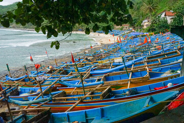 Fisherman traditional wooden boats captured at the coastal areas after sunrise.