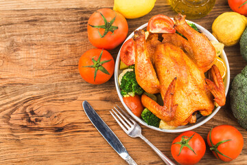 roasted chicken and vegetables on wooden table