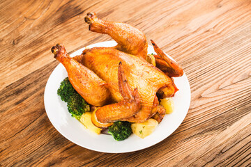 roasted chicken and vegetables on wooden table