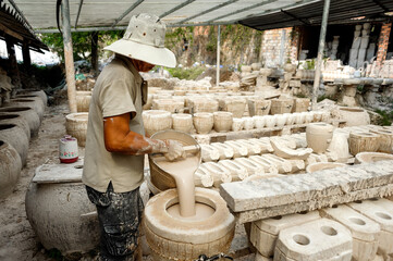 The man is working at a ceramic factory in Binh Duong province, Vietnam.