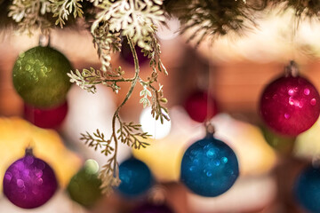 New Year's multi-colored balls hang from above. Christmas decorations