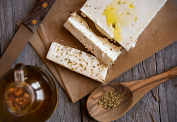 Cut feta cheese with olive oil and dry herbs