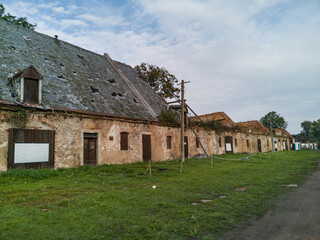 Fototapeta na wymiar Old ruined barracks in small old village