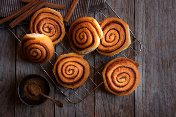 Fresh home baked sweet cinnamon buns on dark background