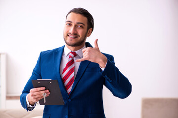 Handsome male realtor working indoors