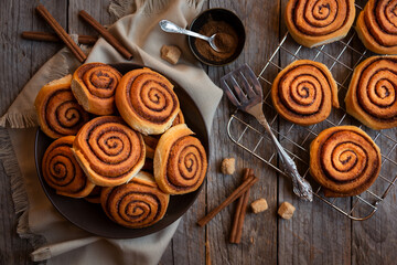 Fresh home baked sweet cinnamon buns on dark background