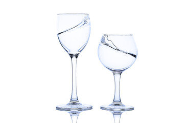 Splash of liquid in glasses isolated on white background