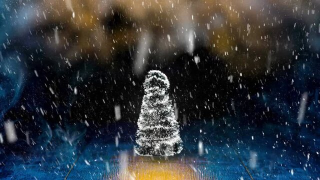 christmas tree spinning with blinking lights under falling snow on colorful abstract background 