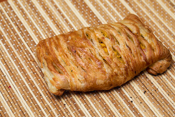 Puff pastry with vegetables and meat, sprinkled with black pepper.