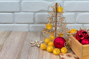 New Year card. Christmas tree and snowflakes carved from wood, a bag with gifts, New Year's balls.