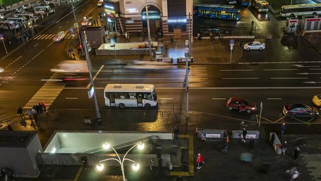 Top view of a busy square with crowds, crosswalks, heavy traffic and bus terminals, time lapse