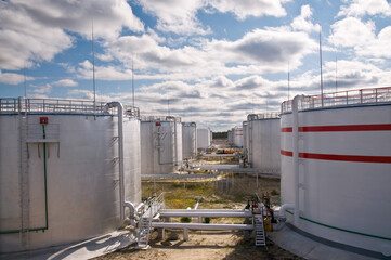 Tanks for storing petroleum products in a large industrial area. View from the oil reservoir.