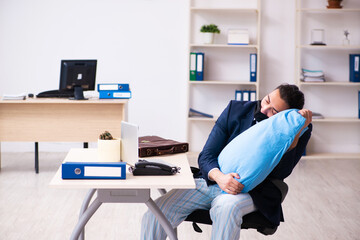 Young male employee during pandemic at workplace