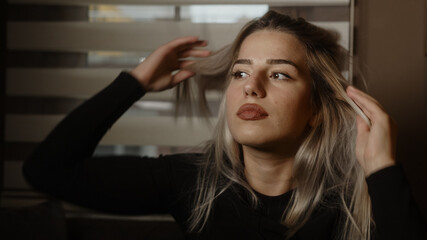 Fototapeta premium Young bored blonde woman poses looking at camera, lifestyle and pandemic concept