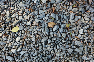 Grey ground stone rubble road background. Natural gray granite chippings, macadam, rubble or crushed stones texture, top view