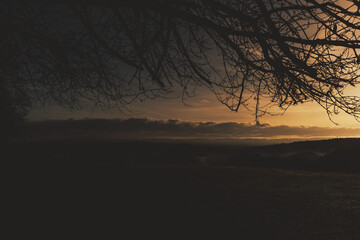 Sunrise in the low mountains with ground fog