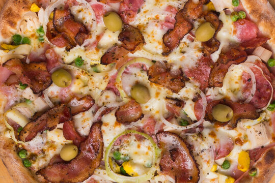 Portuguese pizza made with ham, pea egg, heart of palm, pepperoni, onion and mozzarella and bacon. Macro photography of gastronomy. Pizzeria e restaurant Pictures.