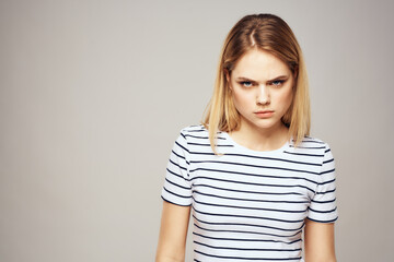 Obraz premium Emotional blonde woman in striped t-shirt lifestyle facial expression close-up