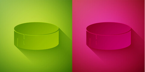 Paper cut Hockey puck icon isolated on green and pink background. Sport equipment. Paper art style. Vector Illustration.