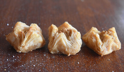 three small baklava with filo pastry and pistaccio